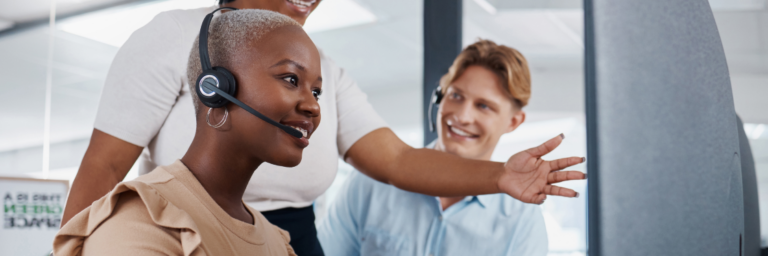 Customer service representatives engaging with a colleague in a modern office setting, utilizing Biteable video maker.