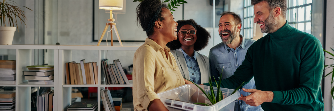 Why you can’t afford a poor offboarding experience Four colleagues sharing a light-hearted moment in an office environment, creating content with Biteable video maker.