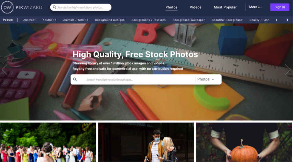 A desktop with various creative supplies, overlaid by a search interface for free Biteable video maker stock photos from a digital library.