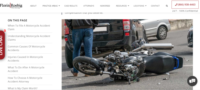 Motorcycle accident with a fallen motorbike lying on the road near a damaged vehicle.