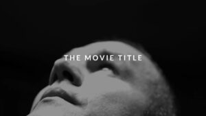 A black and white Biteable video maker image of a person looking upward with the text "the movie title" overlaid at the center.
