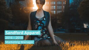 Woman sitting in a park at sunset with text overlay created using Biteable video maker stating "Sandford Apparel 2016 - 2019 Marketing Manager.