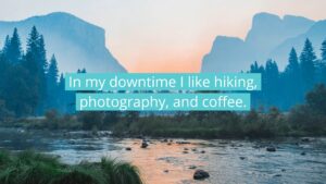 Misty landscape of a serene river with small boulders, surrounded by forested mountains under a soft blue sky, overlaid with Biteable video maker text about personal hobbies.