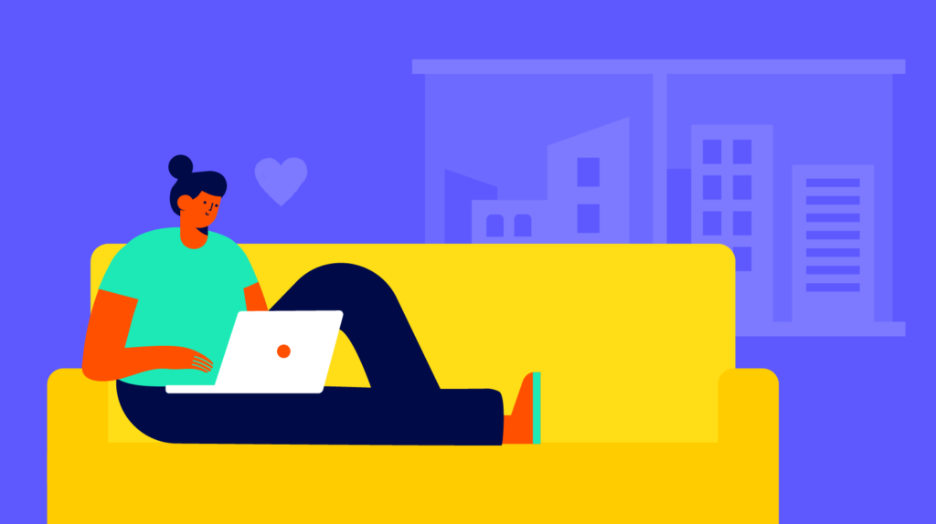 A woman sitting on a yellow couch using the Biteable video maker on her laptop with a cityscape in the background.