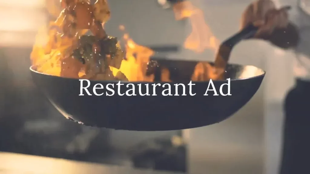 A chef holds a pan in which food is being flambéed, with flames rising from the pan. The text "Restaurant Ad Video Template" appears over the image.