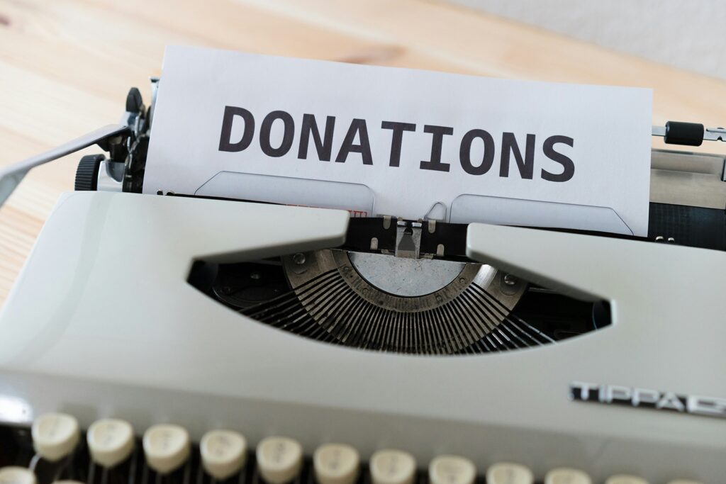 A typewriter with a sheet of paper showing the word "DONATIONS" in bold letters.