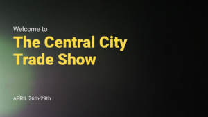 Yellow text on a black background reads: "Welcome to The Central City Trade Show," with "April 26th-29th" in white at the bottom left.